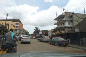 Kampala city scene with boda and car traffic